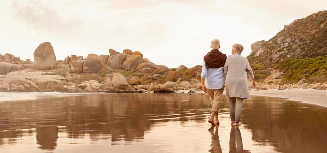 Retired Couple Walking by a Shore